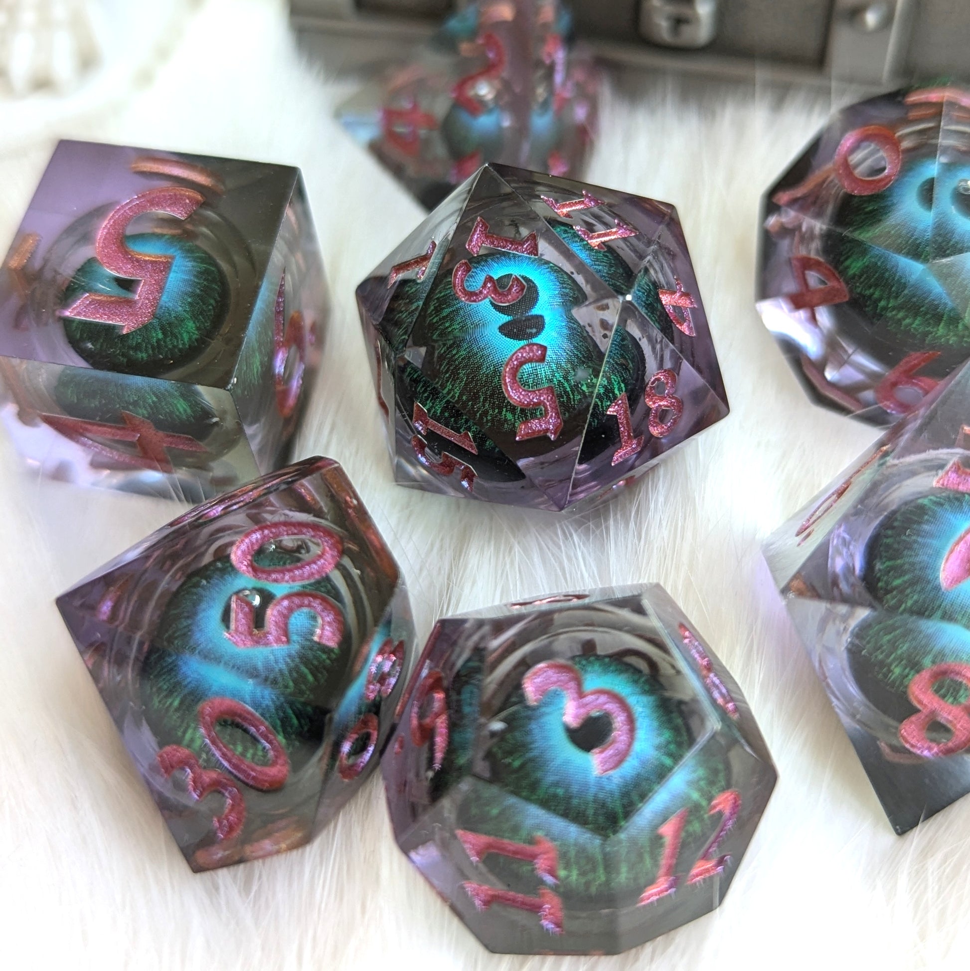 Mystic Eye Liquid Core Sharp Edge Dice Set with blue-green eye and purple resin offering a mystical gaming experience