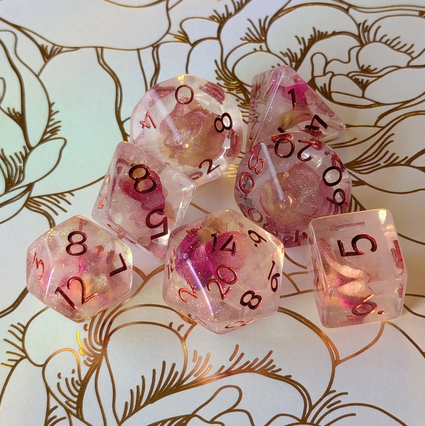 Eternal Rose Dice Set featuring deep pink rose petals in resin with shimmering glitter and metallic red numbers.