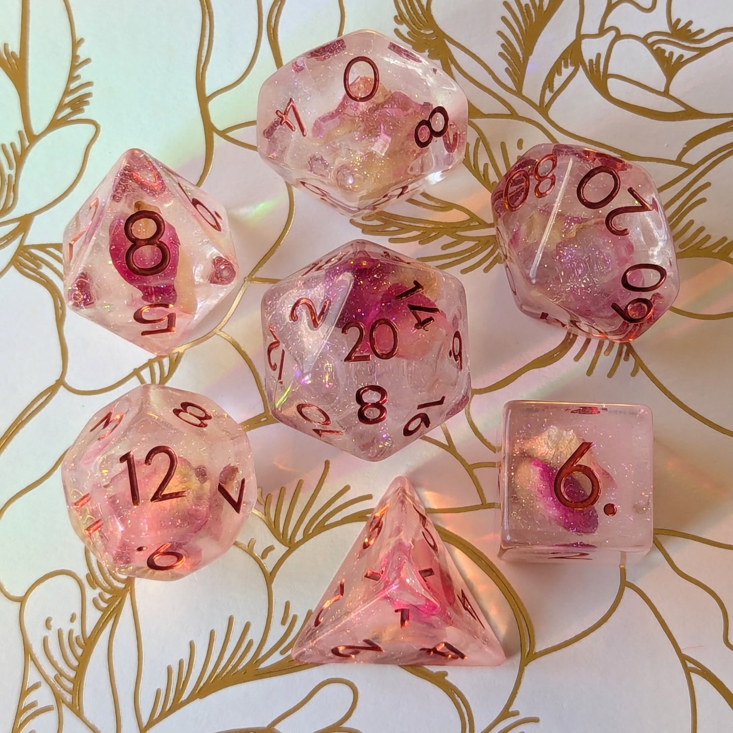 Eternal Rose Dice Set featuring pink rose petals and iridescent glitter in resin, beautifully crafted for tabletop gaming.