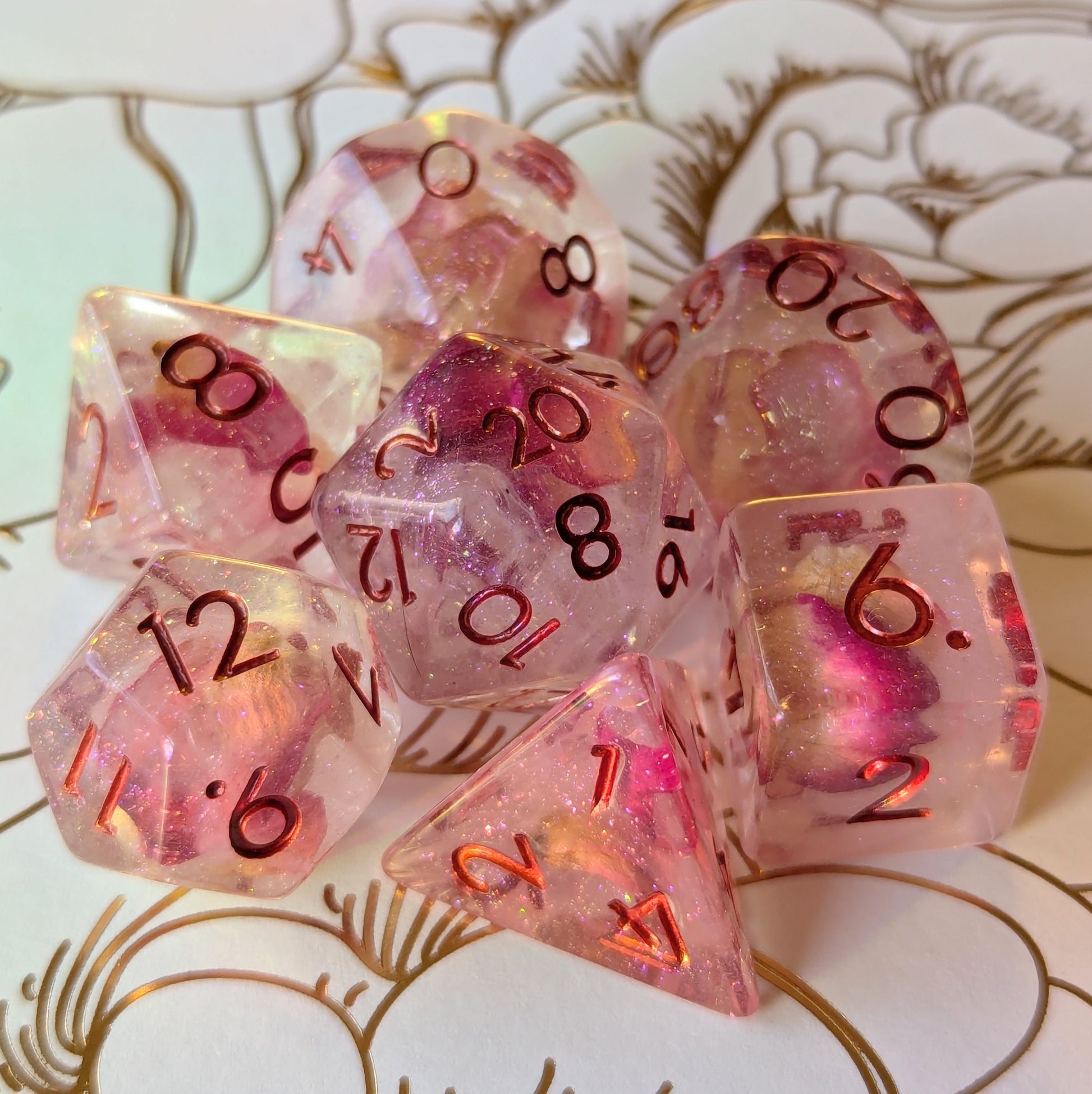 Eternal Rose Dice Set featuring delicate pink rose petals in resin with metallic deep red numbers, showcasing elegance and sparkle.