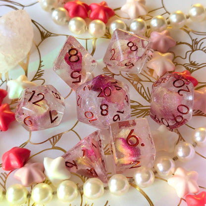 Eternal Rose Dice Set featuring deep pink petals and iridescent glitter, elegantly displayed with decorative beads.