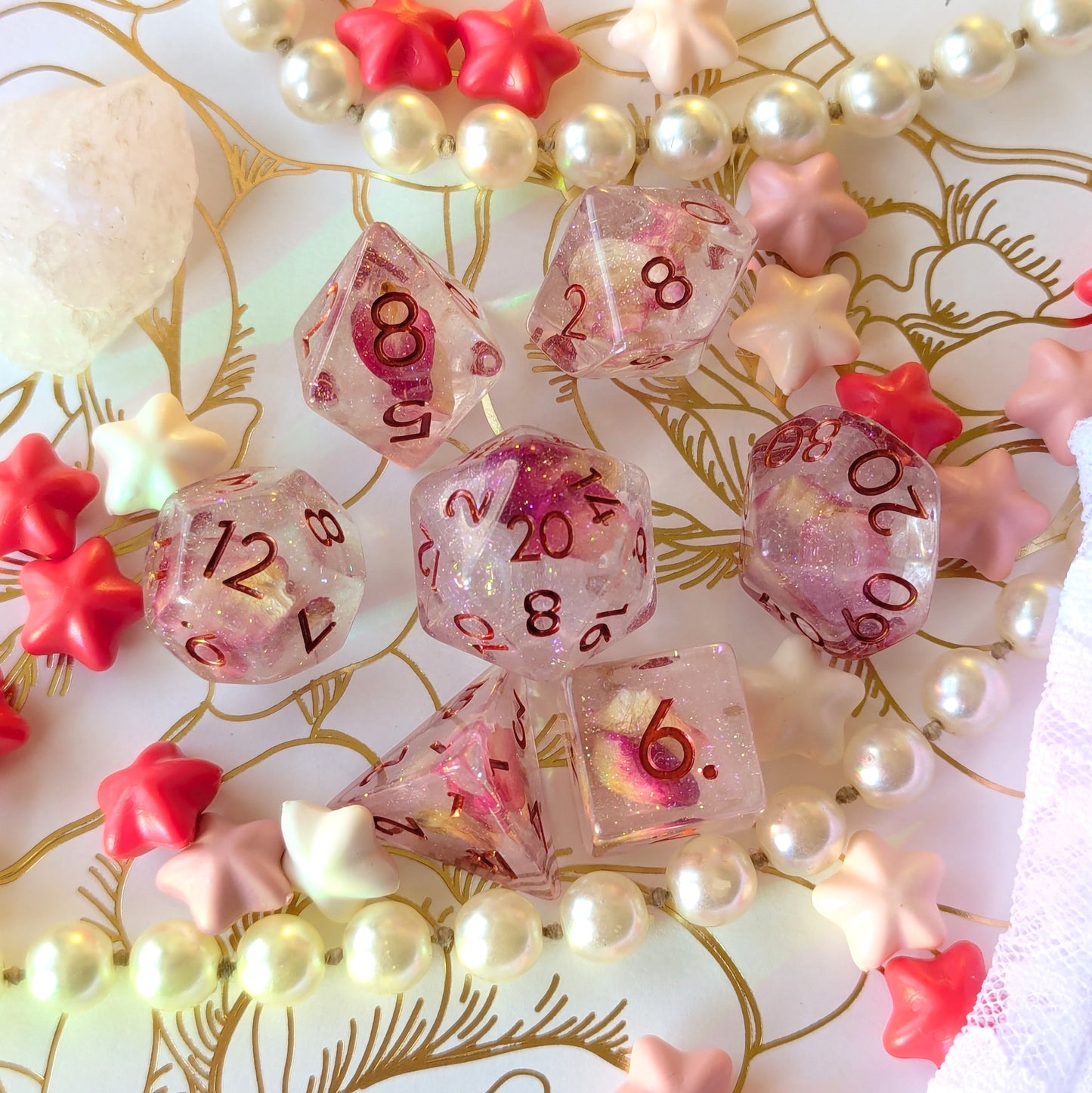 Eternal Rose Dice Set with pink rose petals and glitter, showcasing elegance on a floral background.