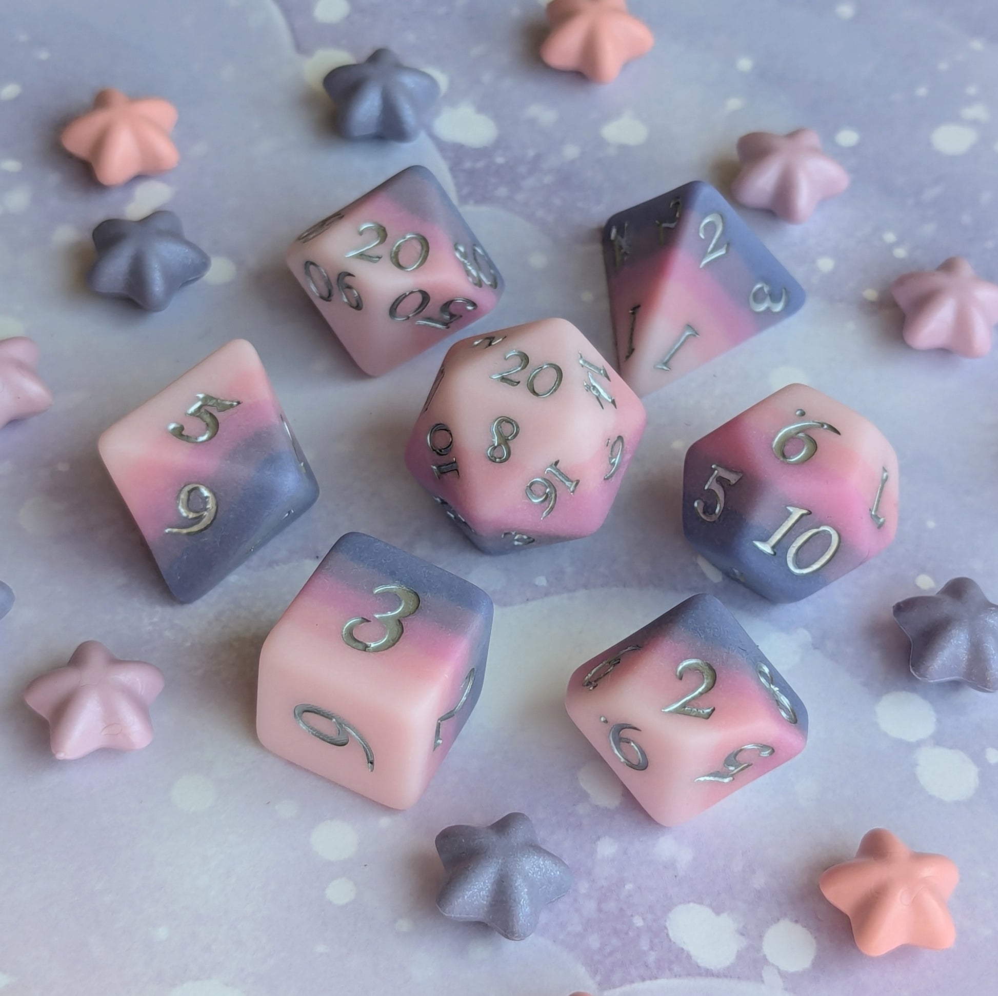 Dreamweaver Dice Set featuring soft pink and lavender colors with silver font on a dreamy pastel background.