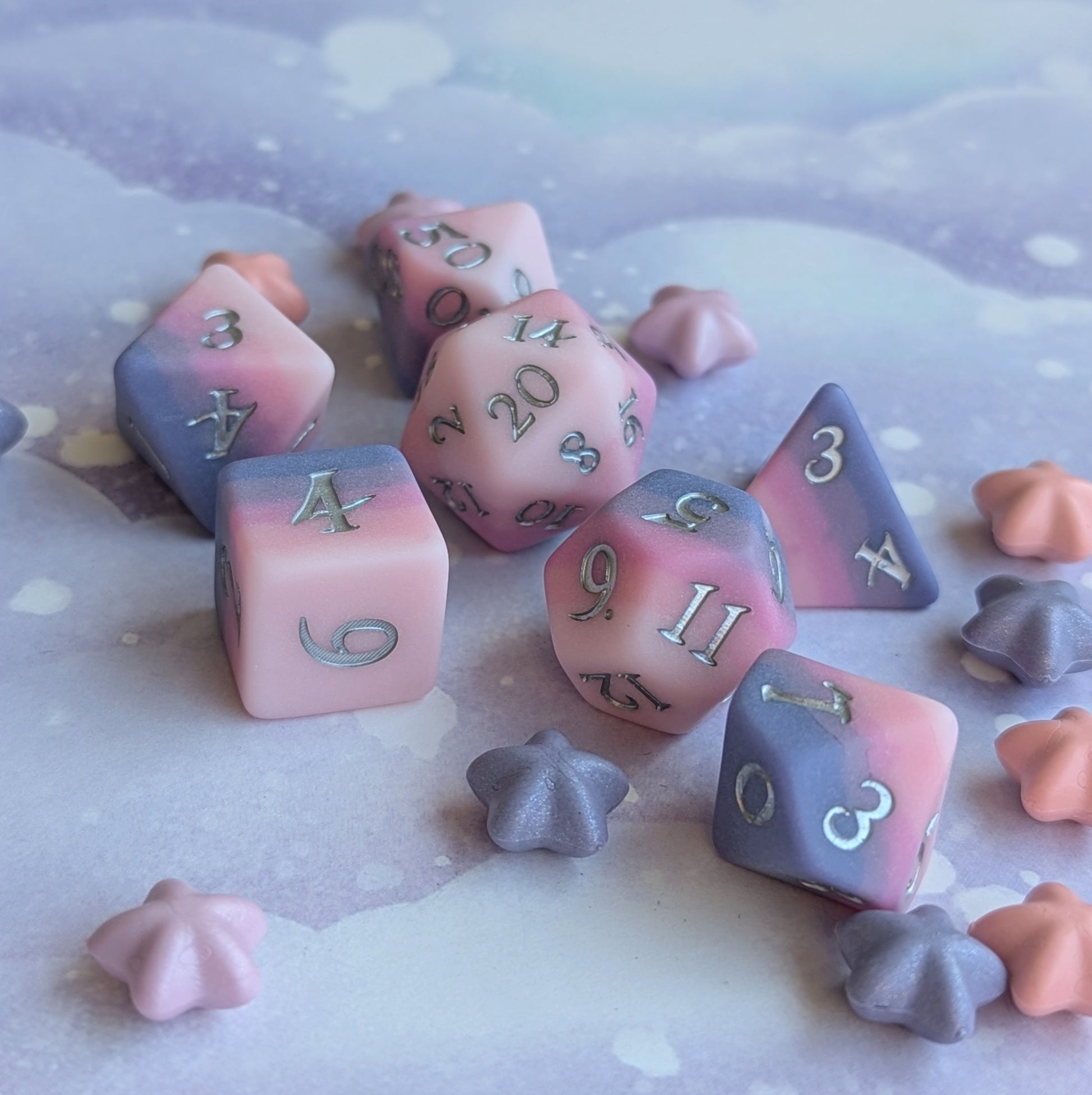 Dreamweaver dice set featuring ombre pink and lavender colors with silver numbers on a dreamy background.