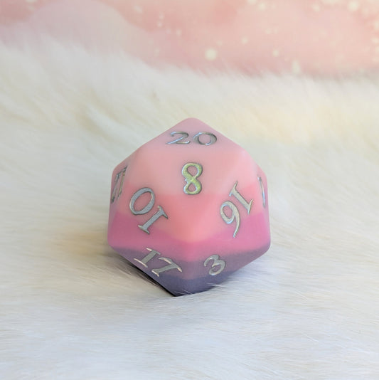 Dreamweaver Large D20 die in matte ombre, featuring pink and lavender hues with silver numbers. Ideal for gaming.