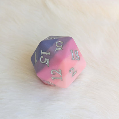 Dreamweaver Oversized D20 die with matte ombre design in pink and lavender hues, showcasing ethereal texture and enchanting colors.