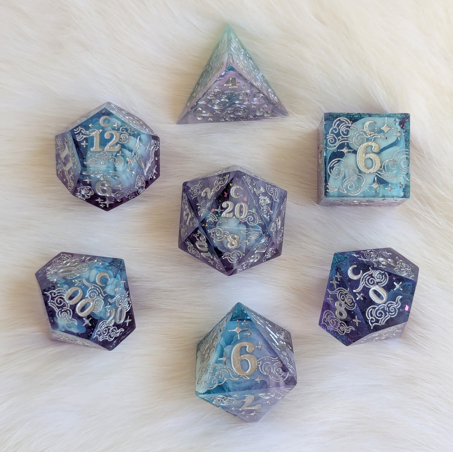 Dreamy Amethyst Sky sharp edge resin dice set featuring clear purple and blue layers with silver engravings on a soft background.