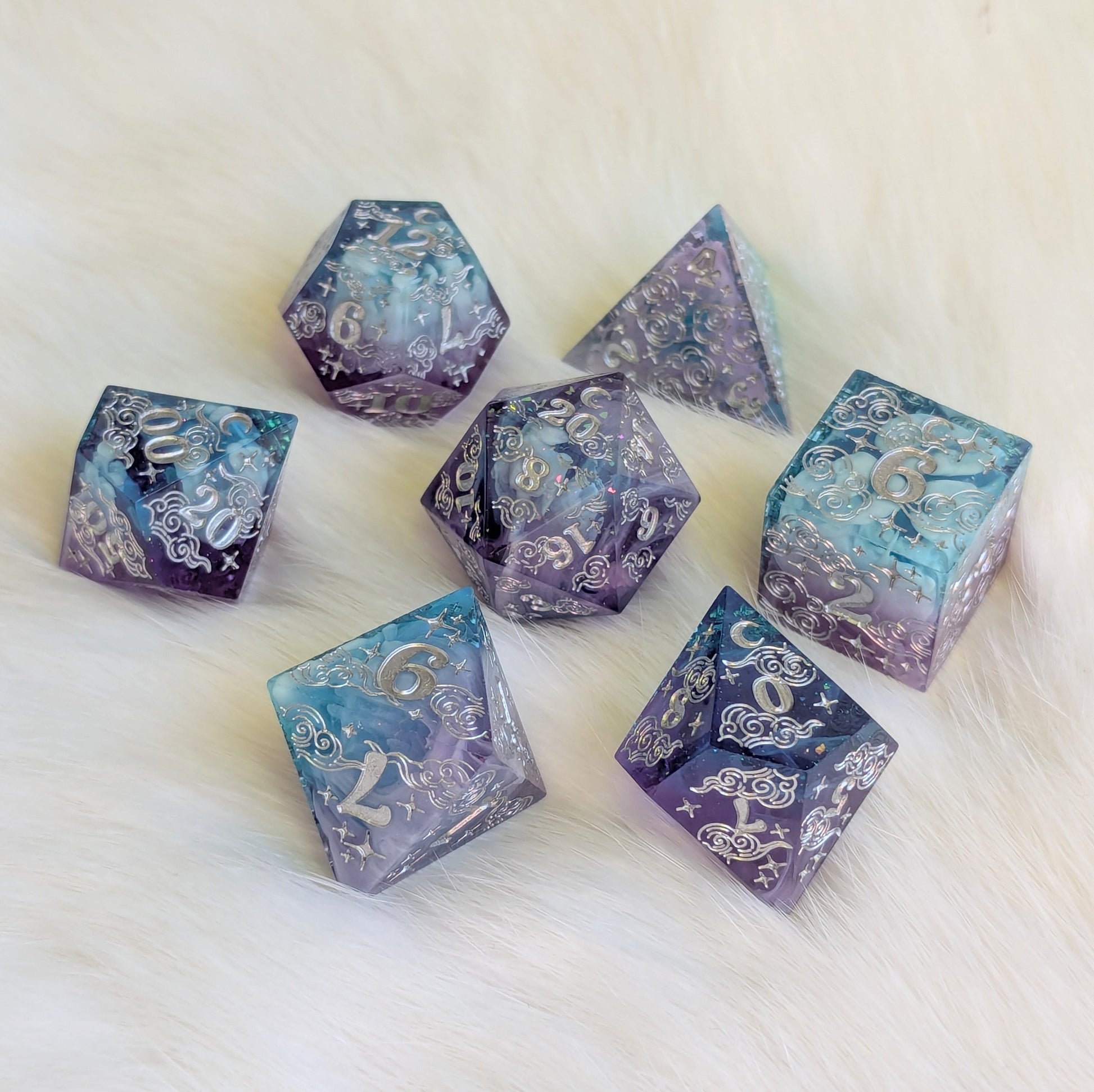 Dreamy Amethyst Sky sharp edge resin dice set with purple, blue, and white clouds, featuring intricate engravings.