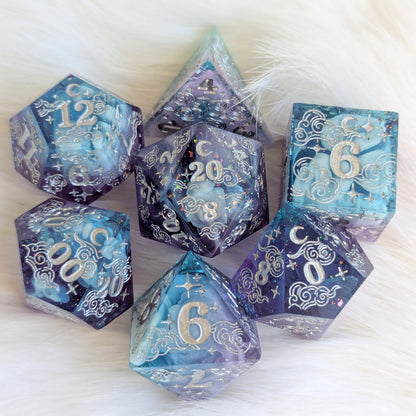 Dreamy Amethyst Sky sharp edge resin dice set with purple and blue layers, glitter, and intricate silver engravings.