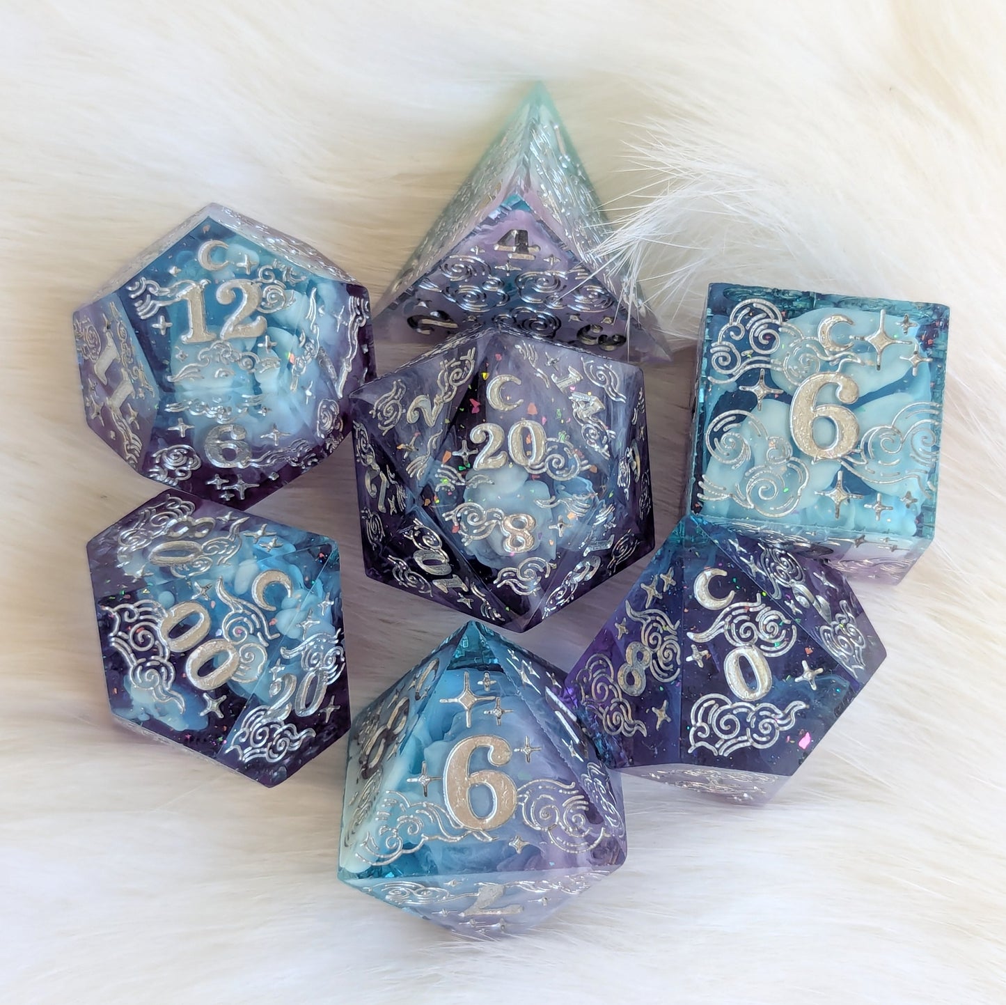 Dreamy Amethyst Sky sharp edge resin dice set featuring purple and blue layers with glitter and intricate engravings.