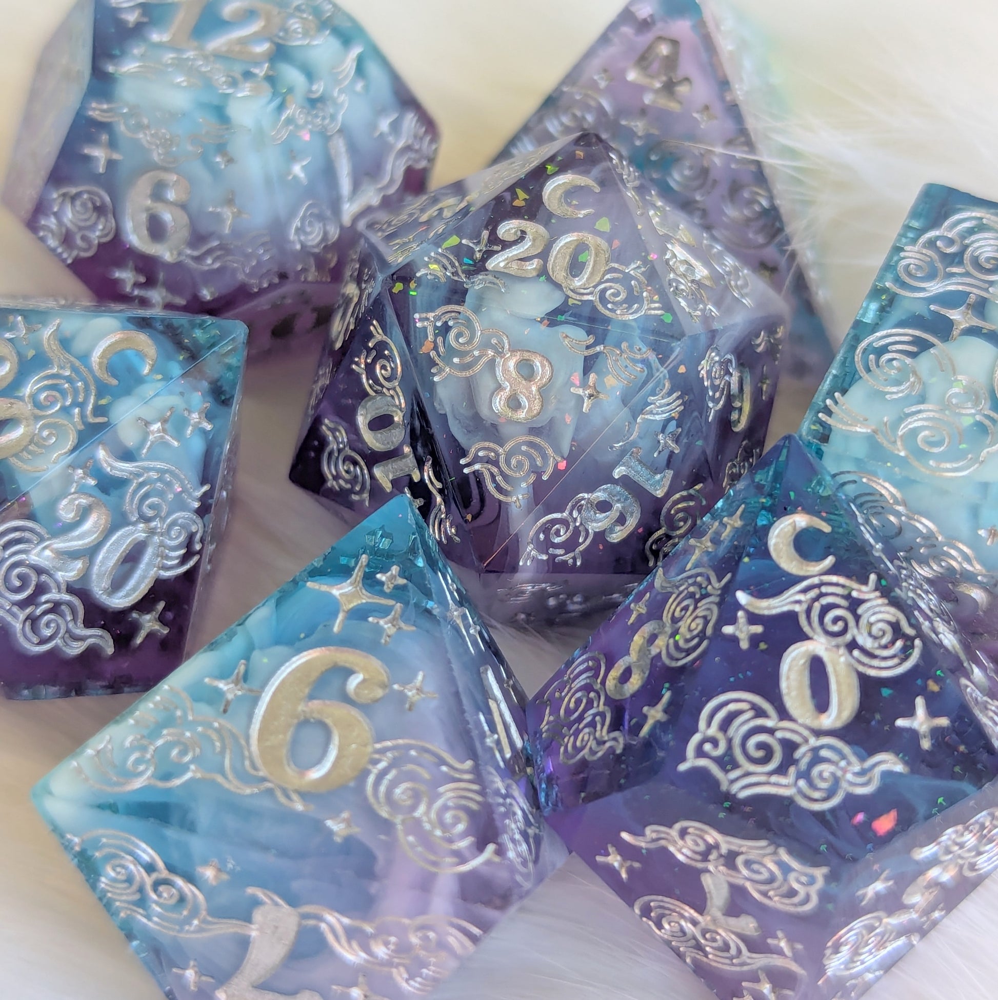 Dreamy Amethyst Sky sharp-edge resin dice set with purple, blue, and white cloud designs, featuring engraved numbers and glitter flakes.