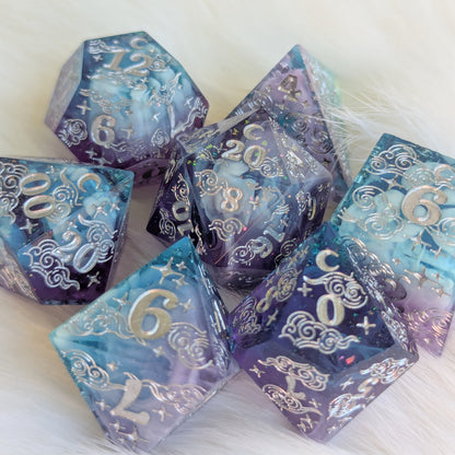 Dreamy Amethyst Sky sharp edge resin dice set with purple and blue layers, engraved numbers, and glittering details.