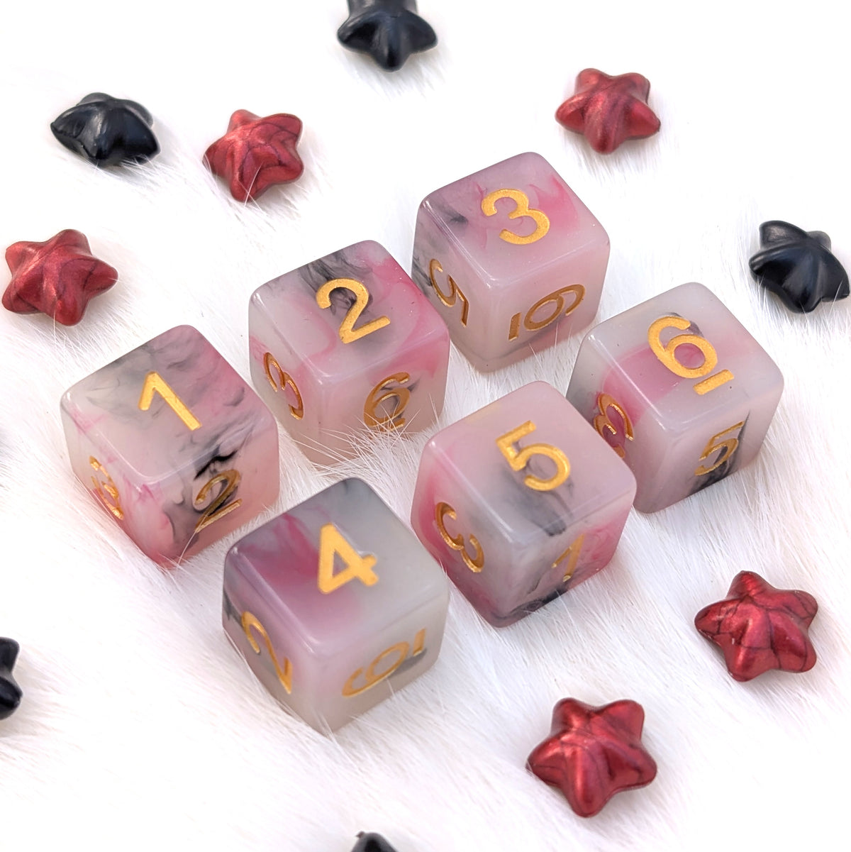 Potion No. 13 six-piece D6 dice set with semi-transparent white resin, suspended red and black ink droplets, and gold numbers