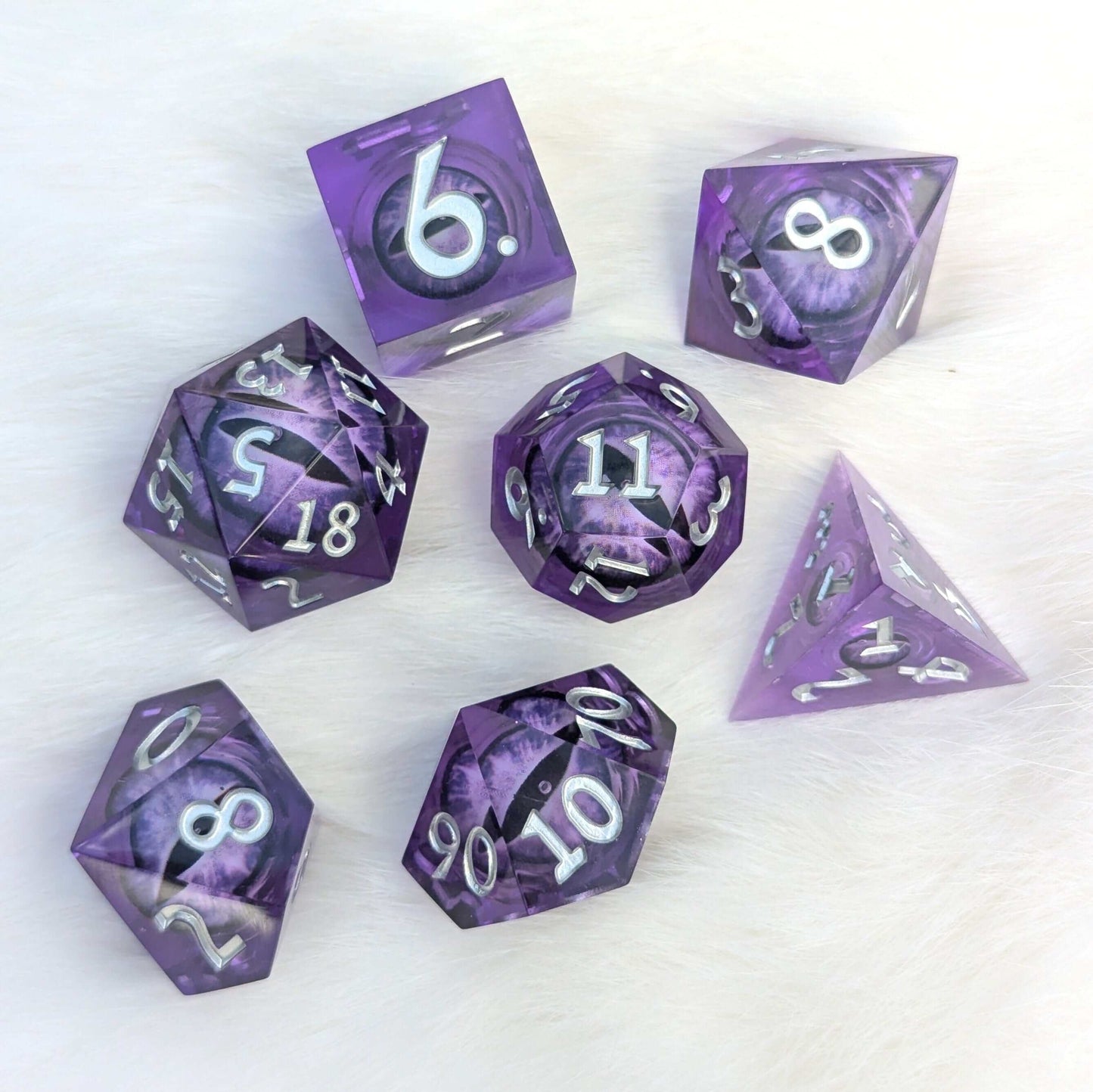 Amethyst Edition All-Seeing Eye Dice Set featuring purple polyhedral dice with a liquid core and moving eye design on white background.