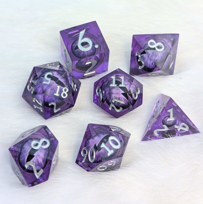 Amethyst Edition All-Seeing Eye 7-piece polyhedral dice set with purple liquid core and sharp edges on white background.