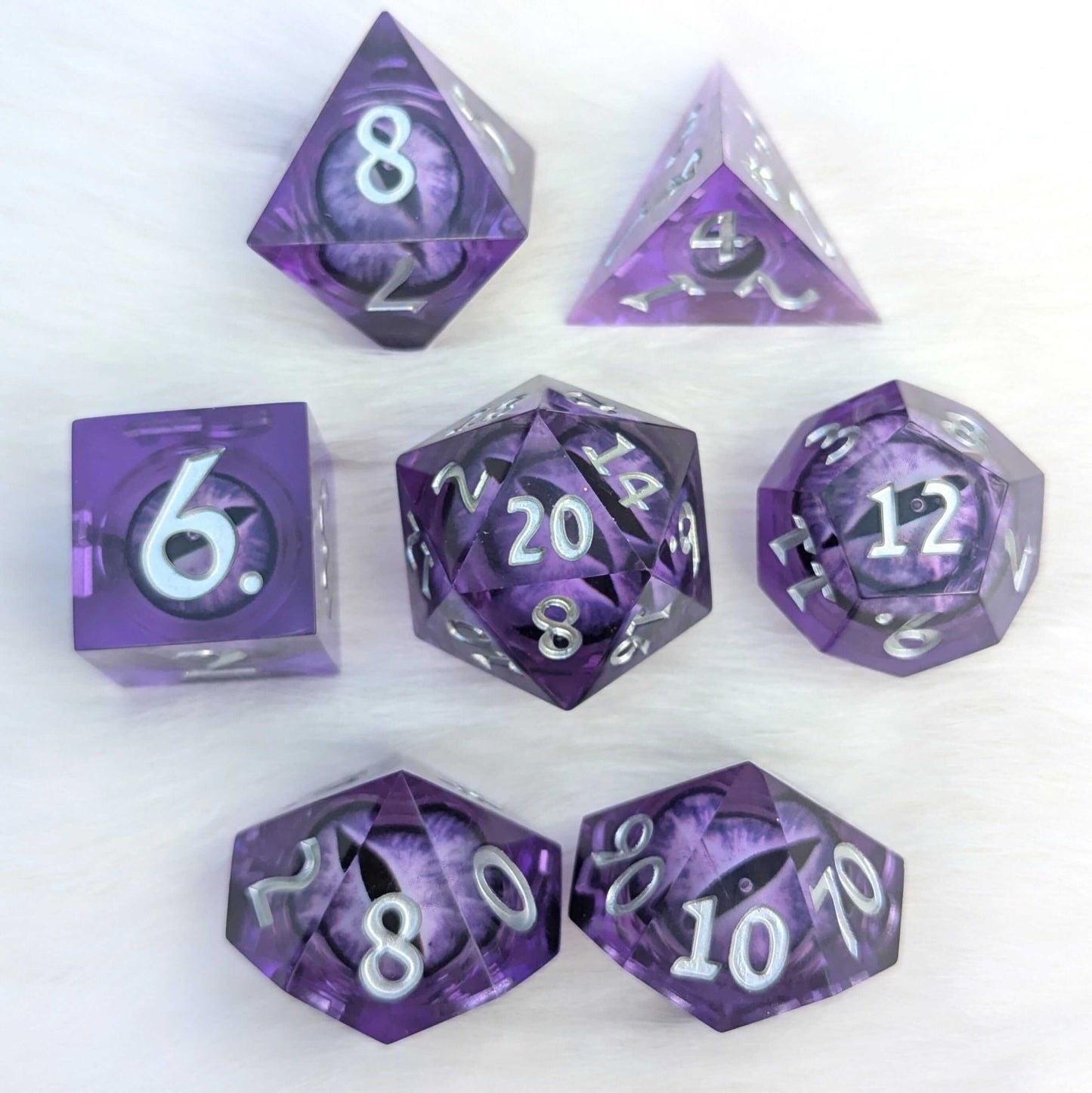 Amethyst Edition All-Seeing Eye Dice Set featuring 7 polyhedral dice with moving purple eyes in sharp edge resin.