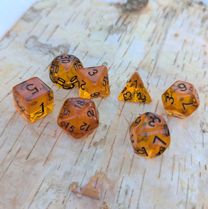 Amber Gems Dice Set with clear auburn-brown acrylic, ideal for tabletop RPGs like Dungeons & Dragons, featuring black numbers.