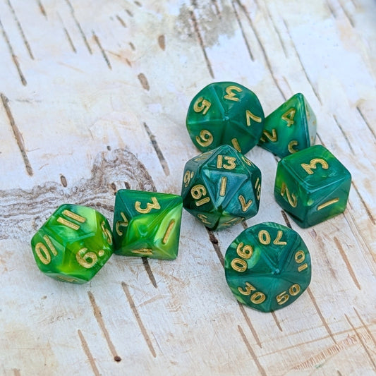 Pearly green Archer's Mini Dice Set for TTRPGs on wooden background, featuring gold numbers and shimmering acrylic finish.