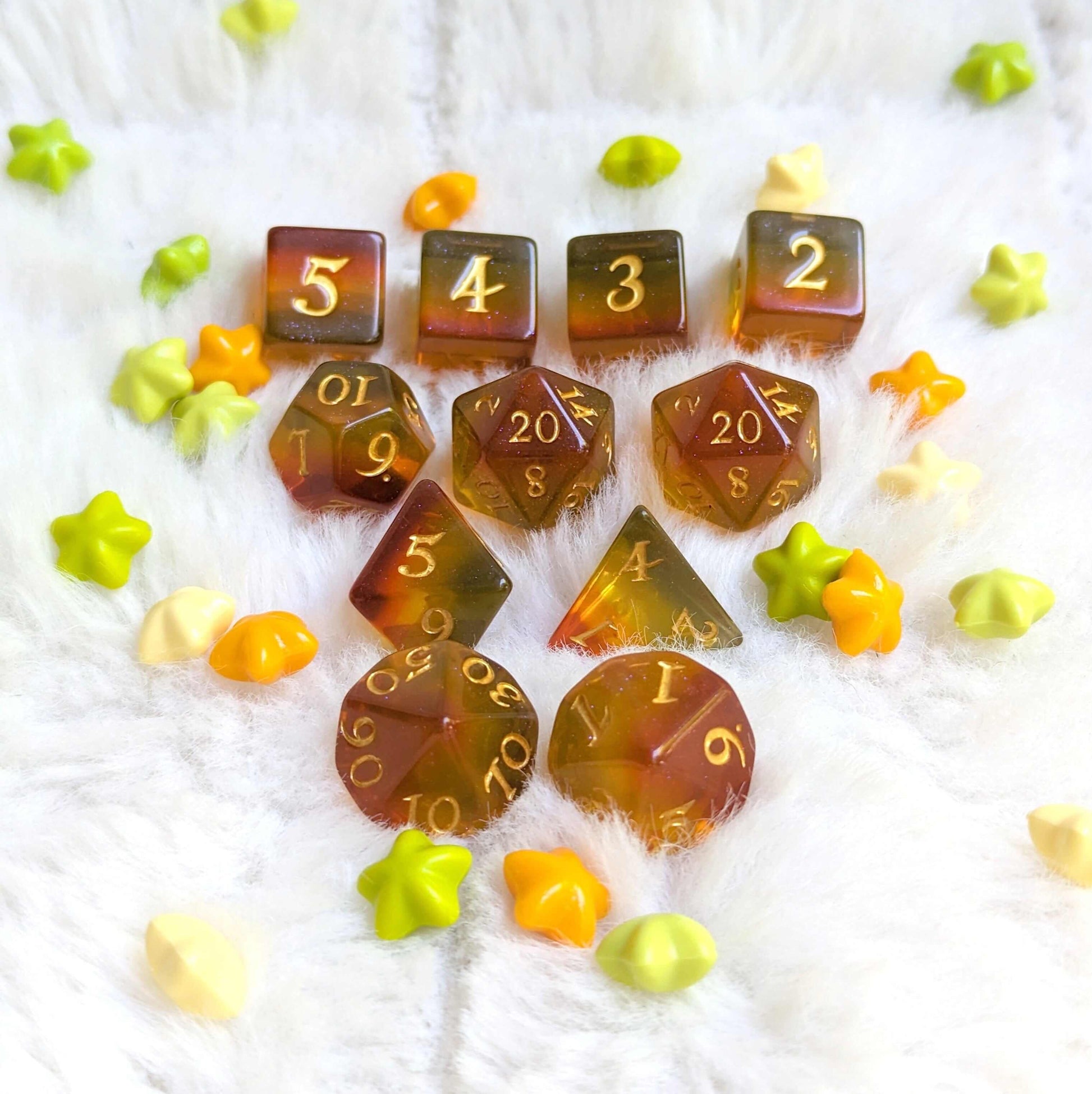 Autumn Sparkles Dice Set featuring vibrant fall colors and glitter, arranged on a fluffy white surface, with colorful star accents.