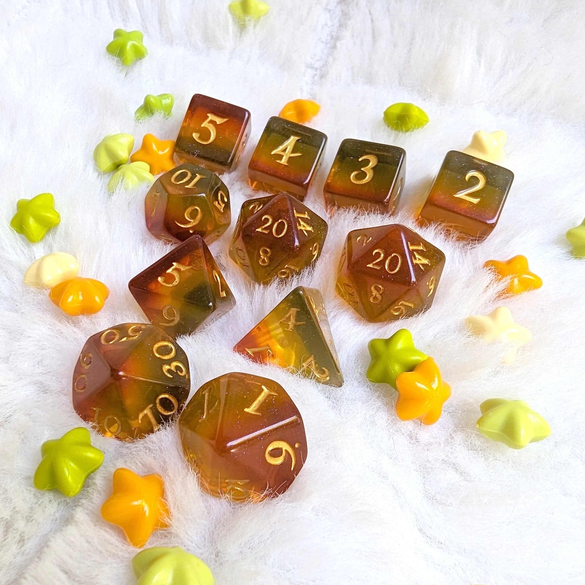 Autumn Sparkles Dice Set with glitter, TTRPG dice in autumn colors, surrounded by leaf-shaped accents on a soft surface.