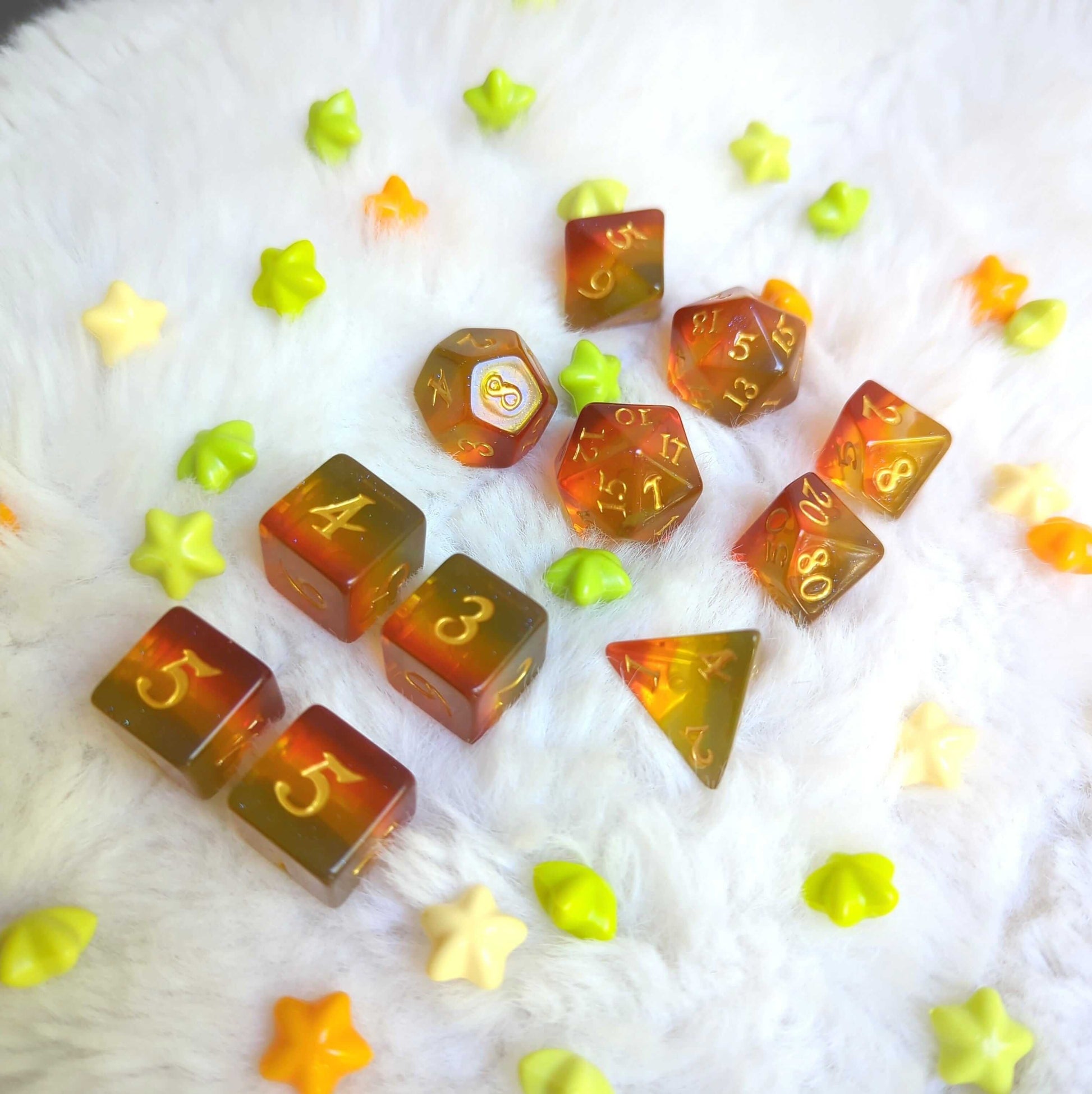 Autumn Sparkles Dice Set with autumn colors and glitter, 7 and 11 pieces displayed on white background for TTRPG games.