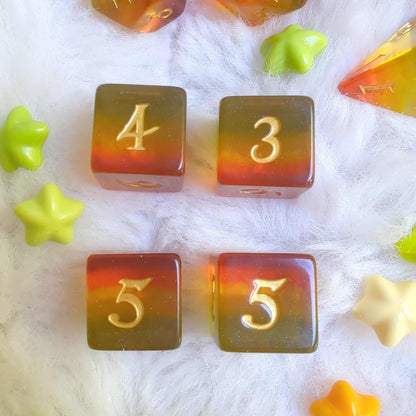 Autumn Sparkles Dice Set showing four TTRPG dice in fall hues with glitter accents on a soft white background.