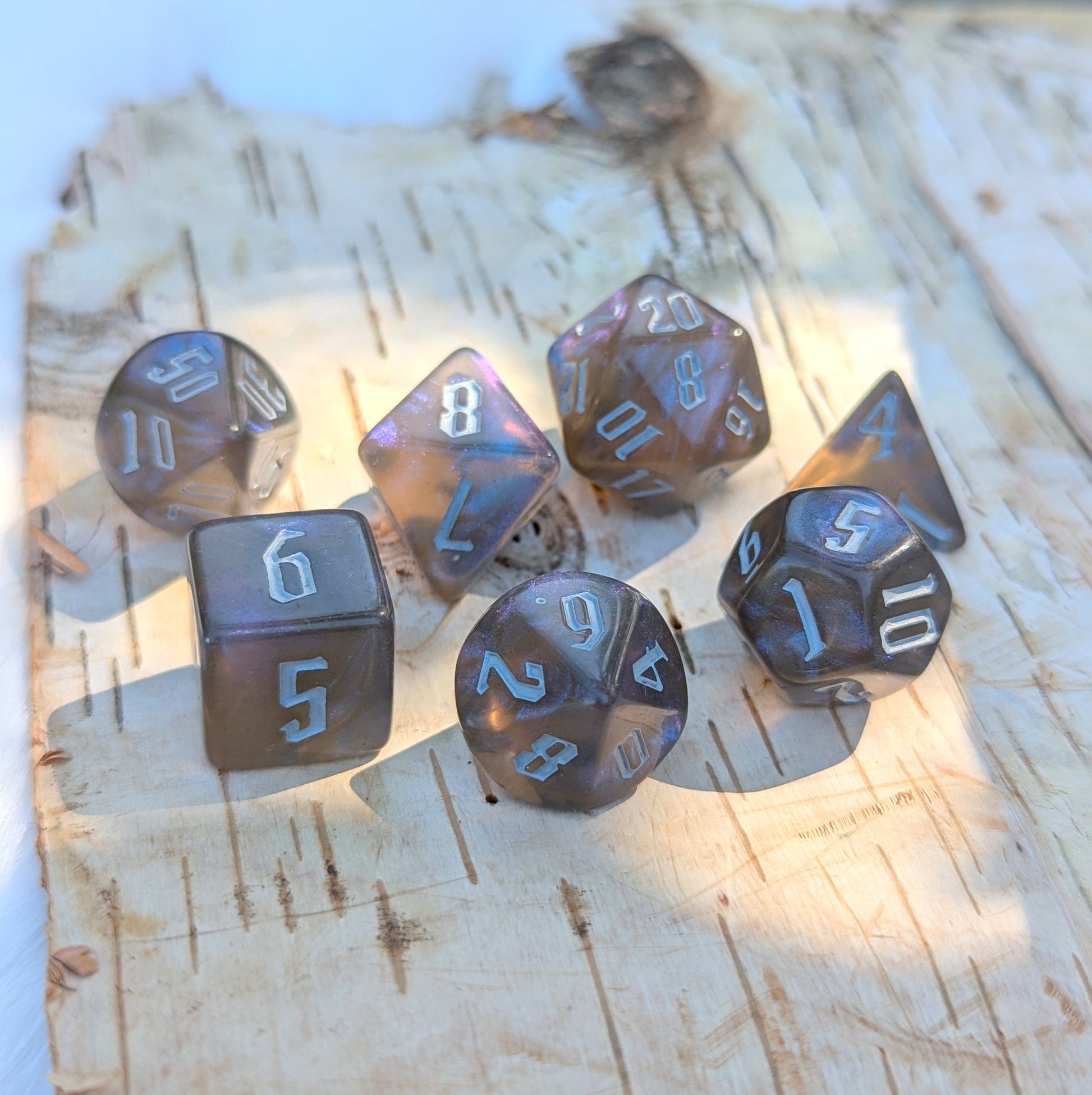 Black and blue glitter acrylic dice set with fantasy font for TTRPG, including D20, D12, D10, D%, D8, D6, and D4.