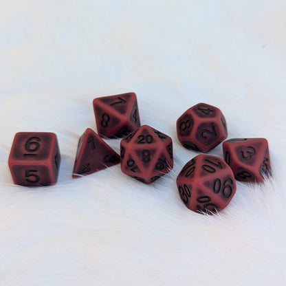 Matte red polyhedral Blood DnD dice set for tabletop RPGs, featuring seven pieces on a soft white background.