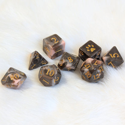 Caramel Macchiato Dice Set on white fur, featuring chocolate and caramel swirled resin TTRPG dice with gold numbers.