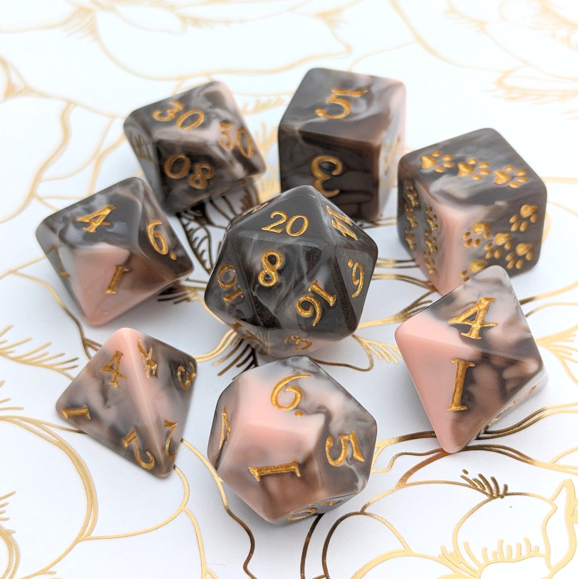 Caramel Macchiato Dice Set with chocolate and caramel swirls, featuring 8-piece TTRPG dice on floral background.