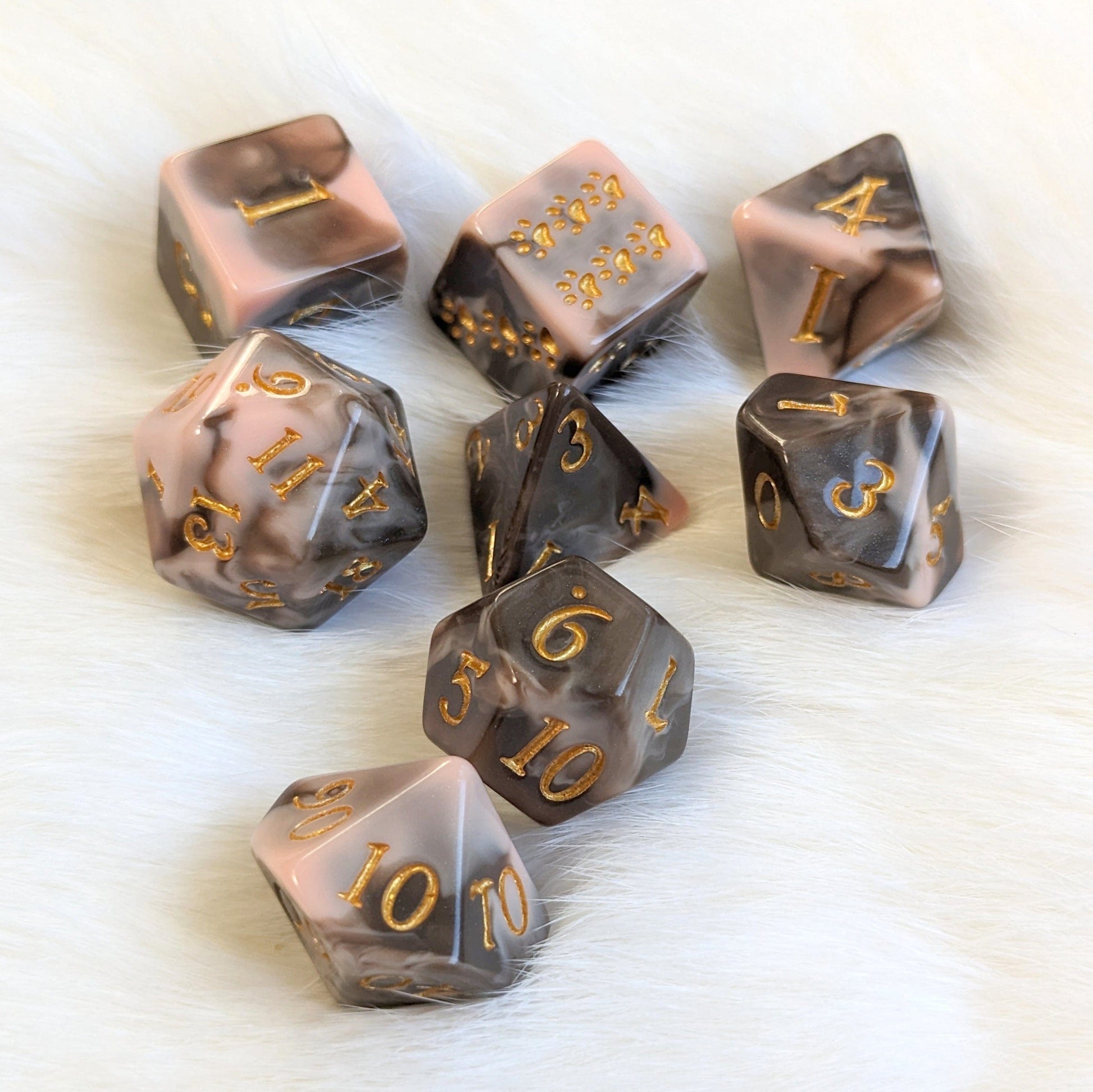 Caramel Macchiato Dice Set with chocolate, caramel, and cream swirls for TTRPG games, displayed on a soft surface.