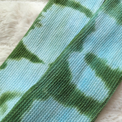 Tie-dyed blue and green cotton fabric close-up of Cozy Sea Elf Socks, showcasing the medium weave and pattern.