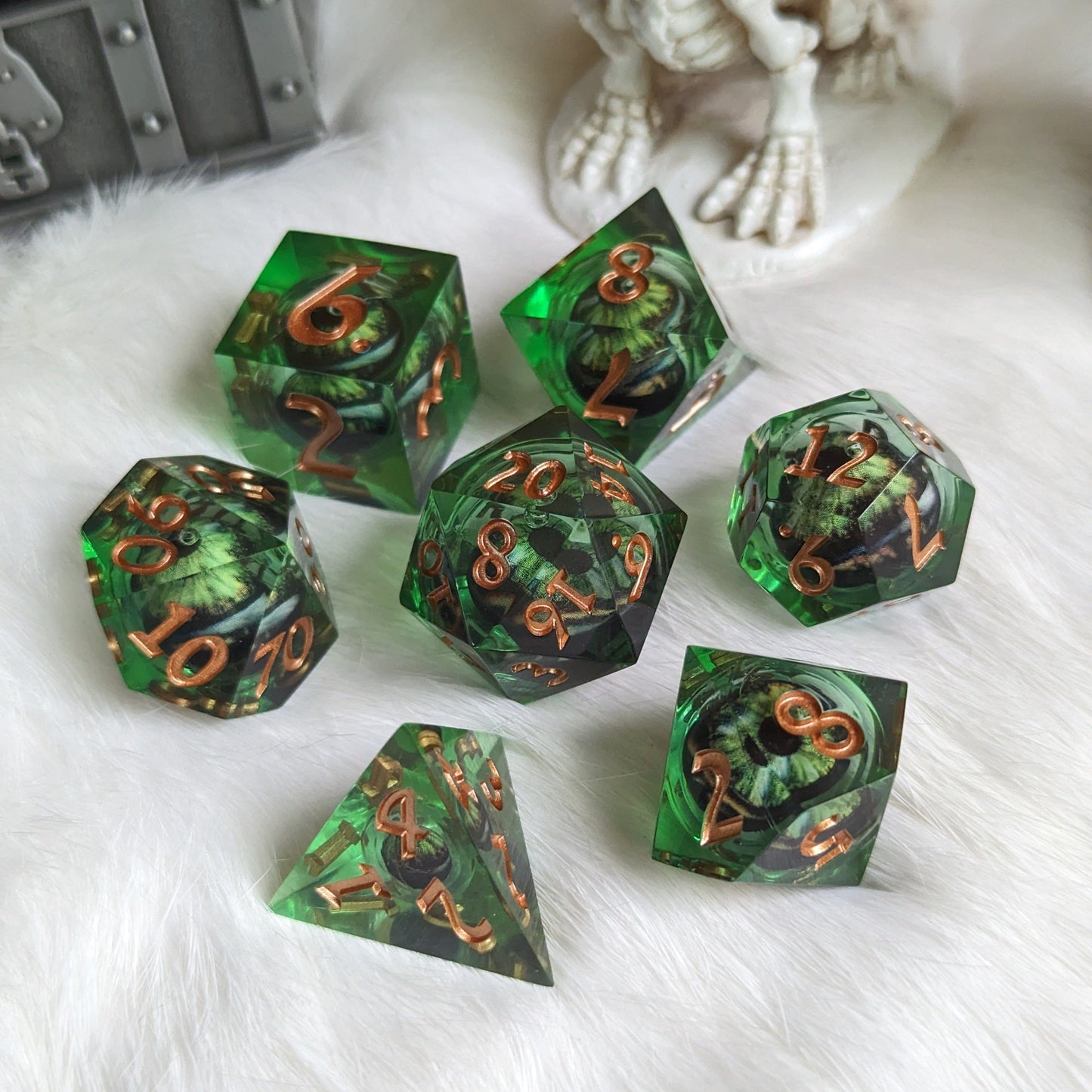 Dark green moving eye liquid core sharp edge resin DnD dice set on a white surface