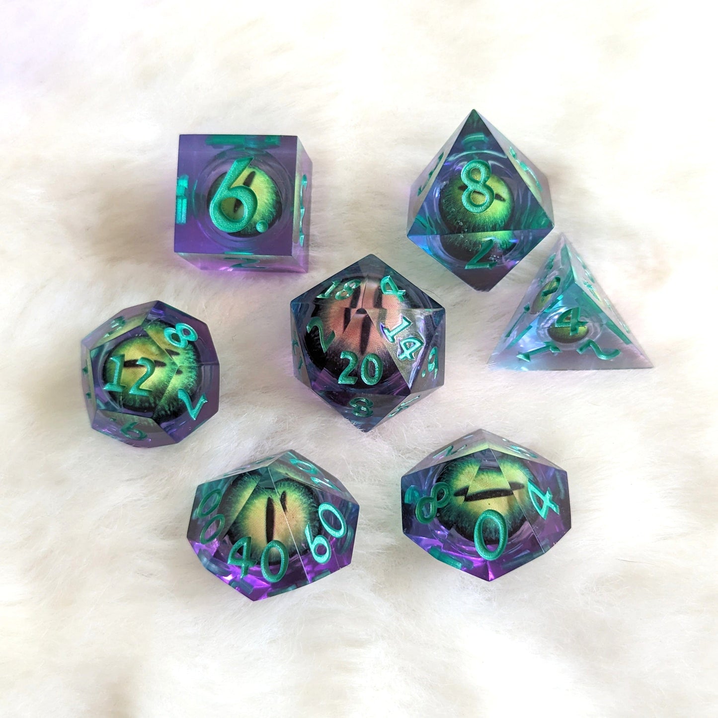 Draconic Moving Eye Liquid Core Sharp Edge Resin DnD Dice Set on white background, showcasing vibrant colors and intricate design.