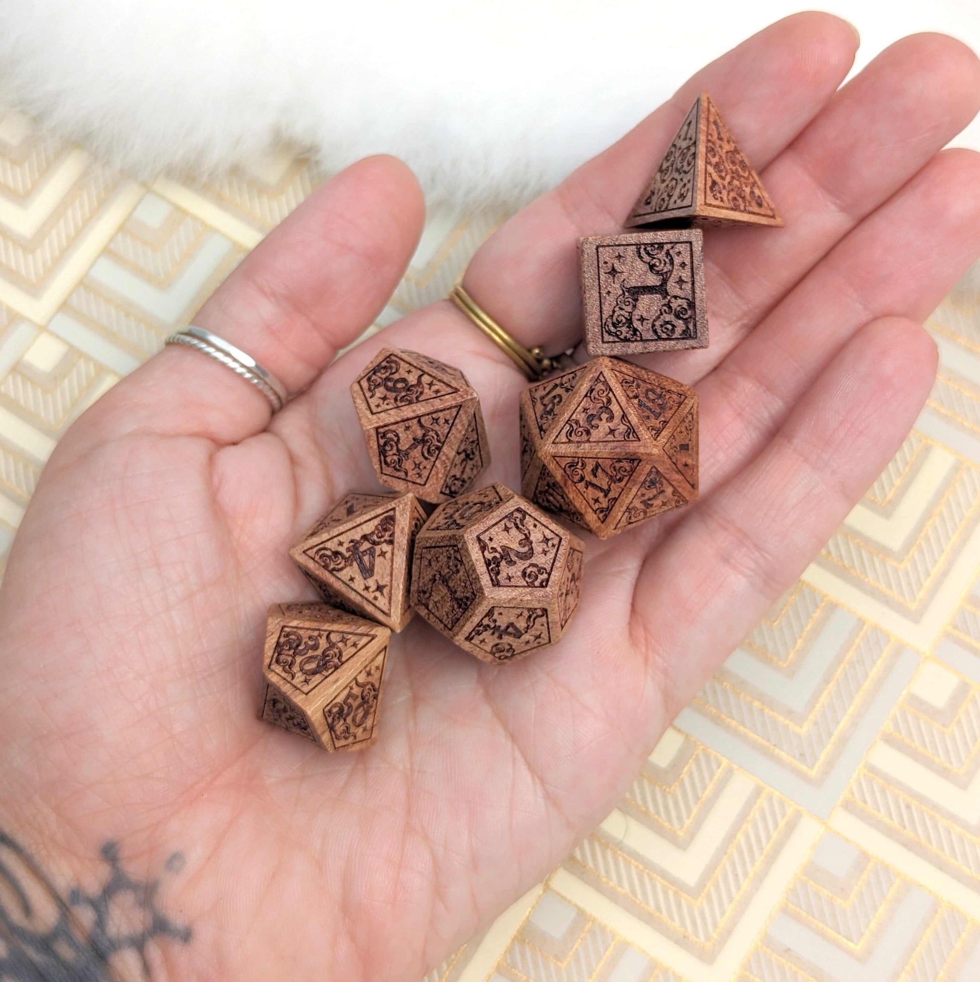 Hand holding Dreamy Star and Moon Wood Dice Set for Dungeons & Dragons gameplay.