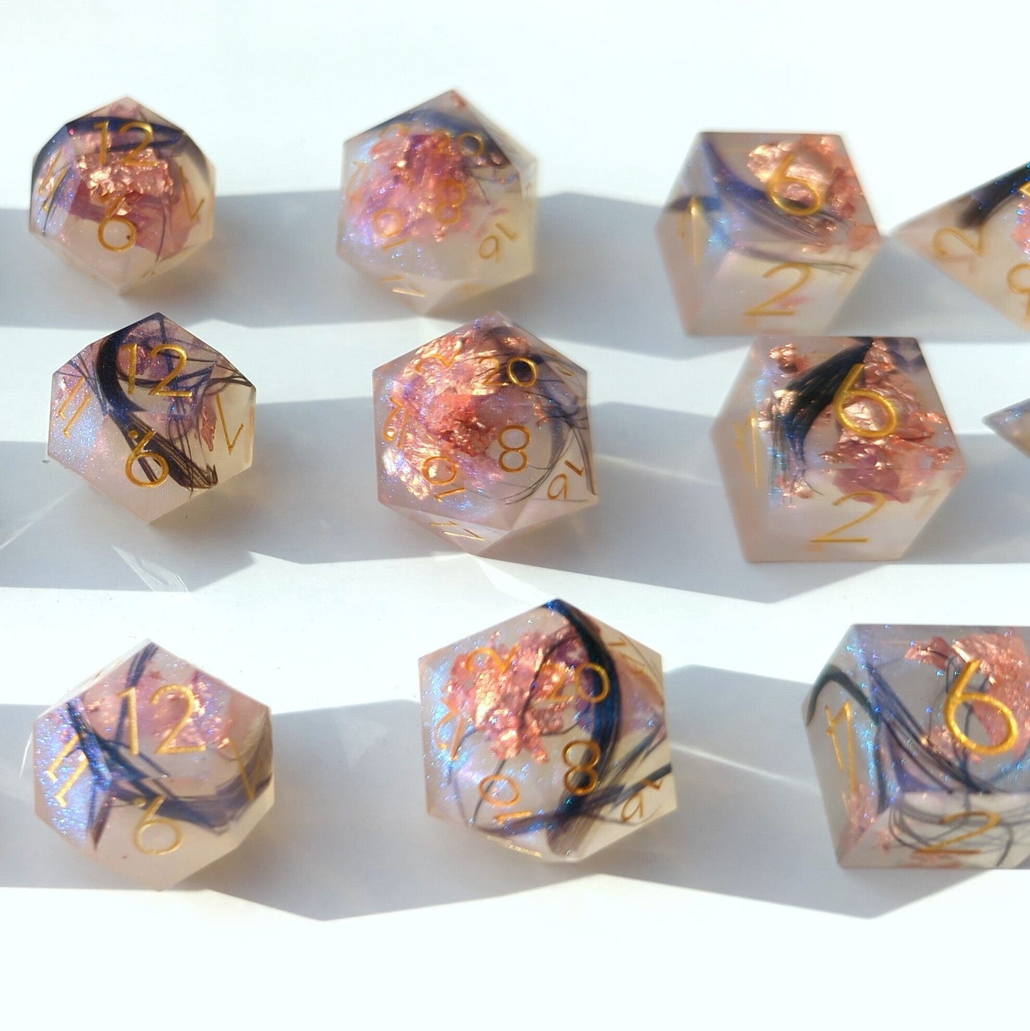 Feather Fall sharp edge DnD dice with black feathers, copper foil, magical misty effect; essential 7 piece set for tabletop games.