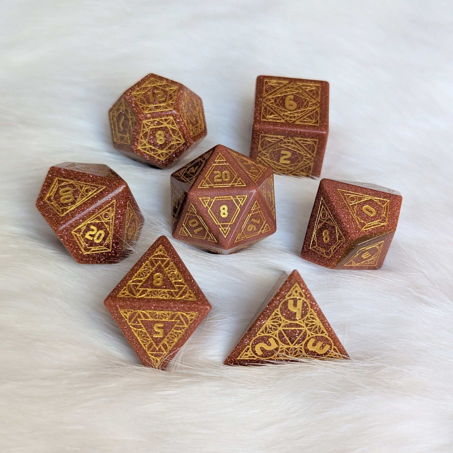 Geometric Goldstone Dice Set with carved stone design, featuring a 7-piece TTRPG set, perfect for tabletop role-playing games.