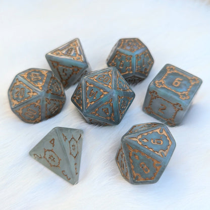 Extra large 7-piece resin dice set with intricate details, featuring a large D20 and D6 on a soft background.