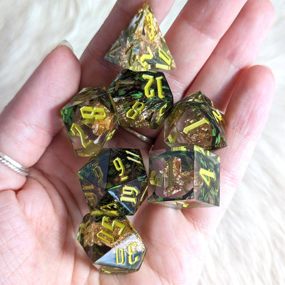 Green Feather Sharp Edge Resin DnD Dice Set with gold foil and light green numbers, perfect for tabletop role-playing games.