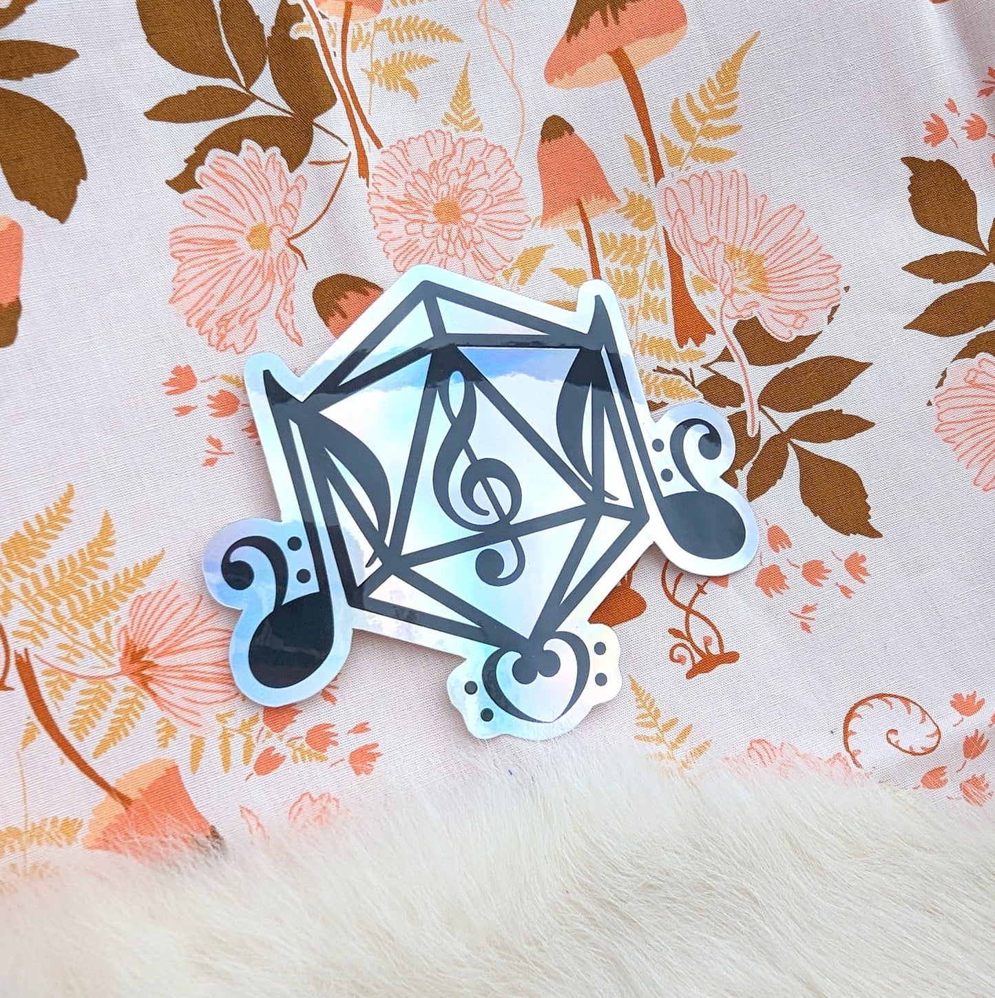 Holographic bard class sticker with music symbols around a D20 frame on floral background, ideal for gaming gear decoration.