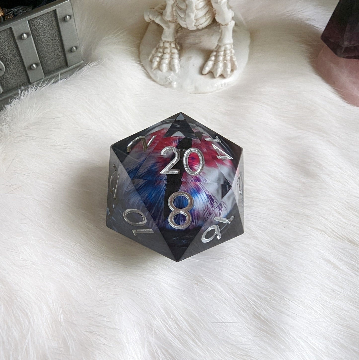 Large Liquid Core Eye D20 die with white, red, and blue glitter, perfect for Dungeons and Dragons and tabletop games.