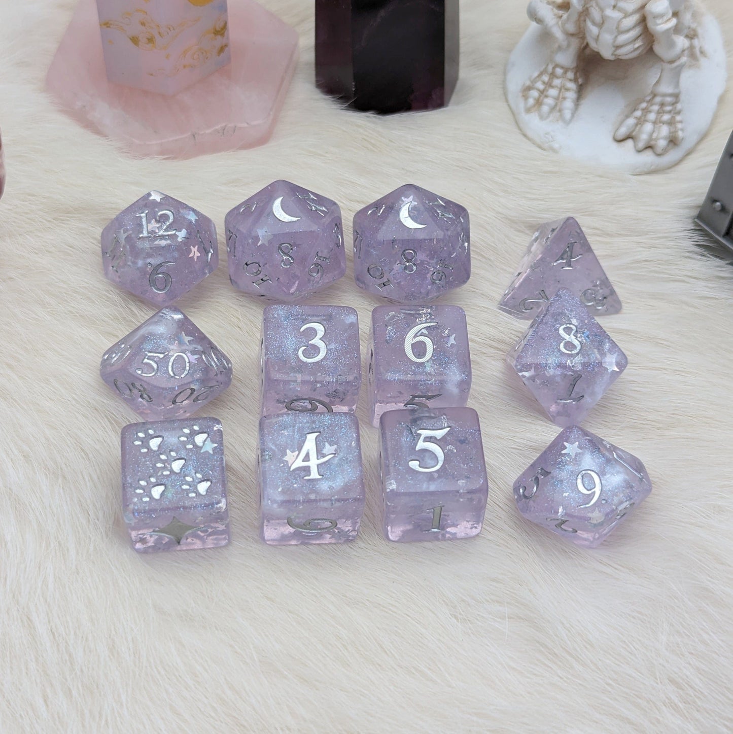 Moonbeam Dice Set with light purple hue, crescent moon design, and star glitter for TTRPG games on soft fur background.