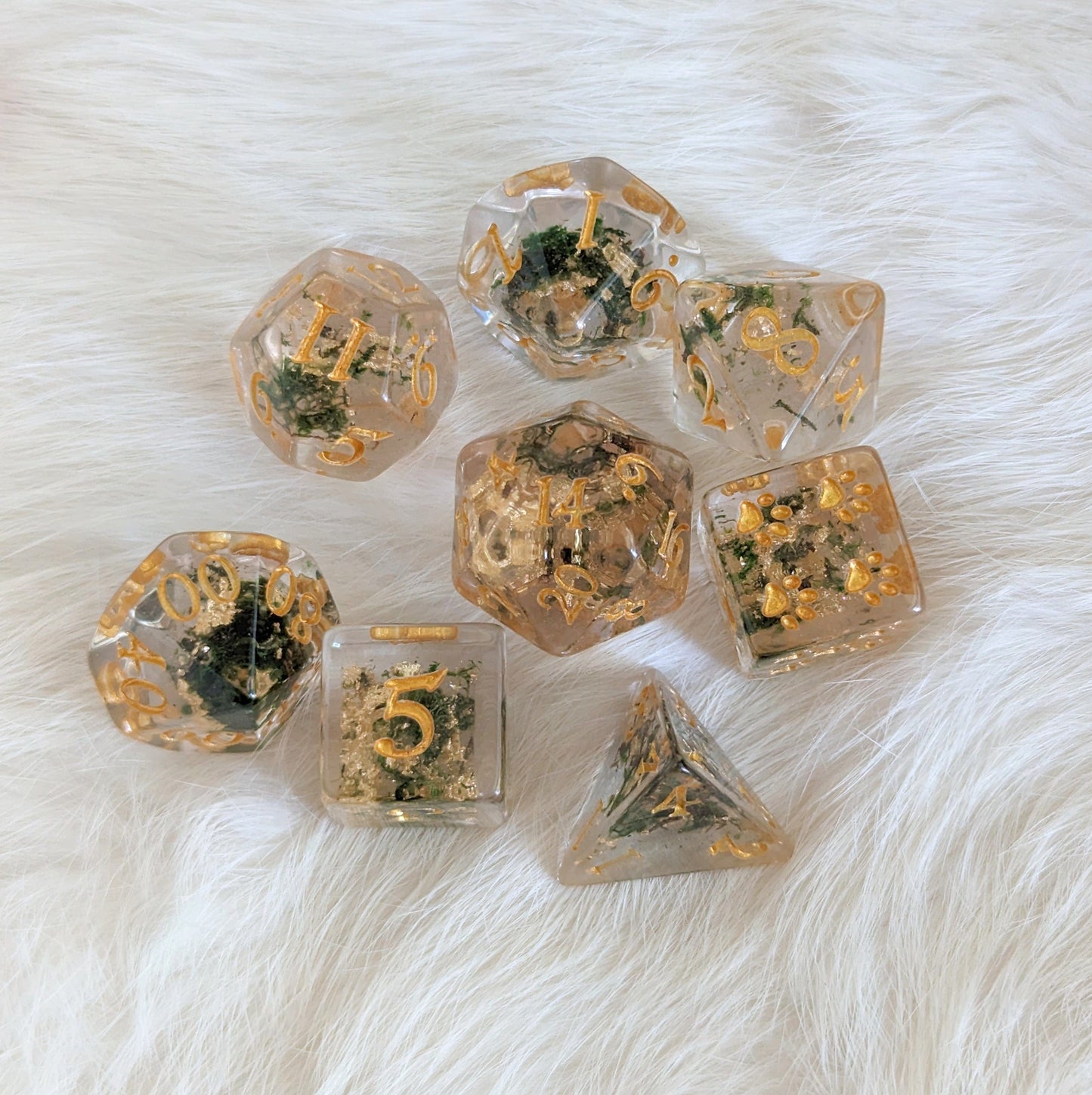 Moss and Gold Dice Set with real dried plants and gold font, 8 piece DND polyhedral dice for TTRPGs on a white background.