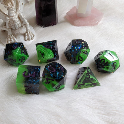 Neon green and black sharp edge DnD dice set with purple numbers on a white background, featuring a swirl design and blue glitter accents.