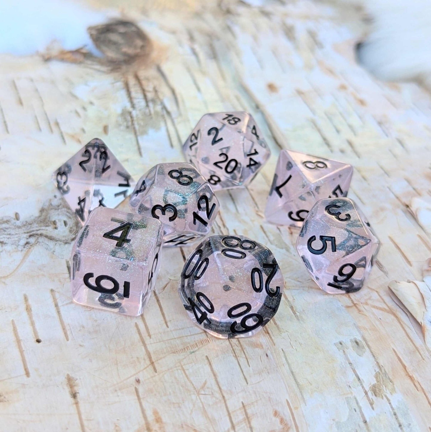 Pink Stardust Dice Set – 7 - Piece Clear Pink Iridescent Glitter Black Font DnD - Fennek and Finch
