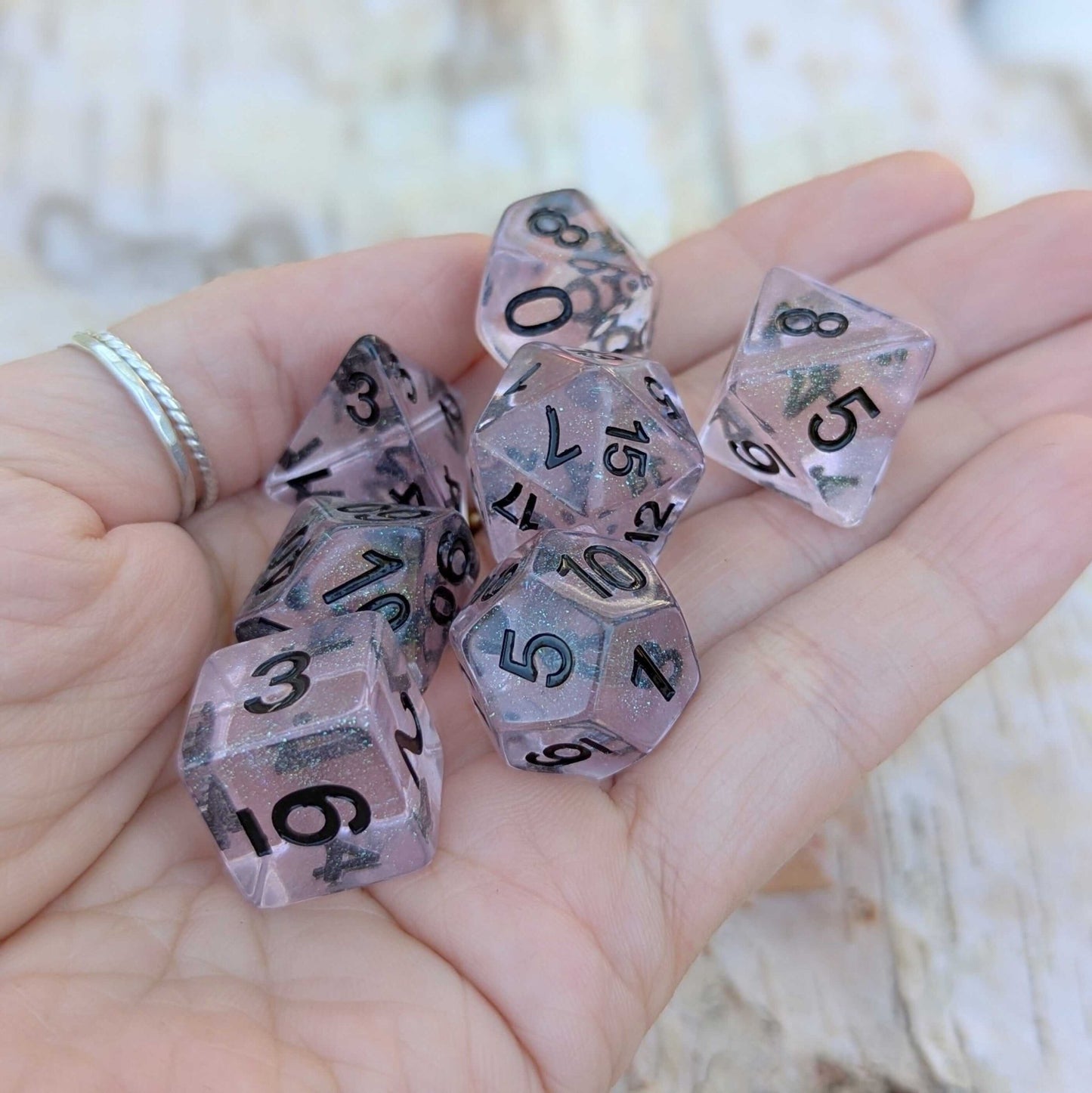 Pink Stardust Dice Set – 7 - Piece Clear Pink Iridescent Glitter Black Font DnD - Fennek and Finch