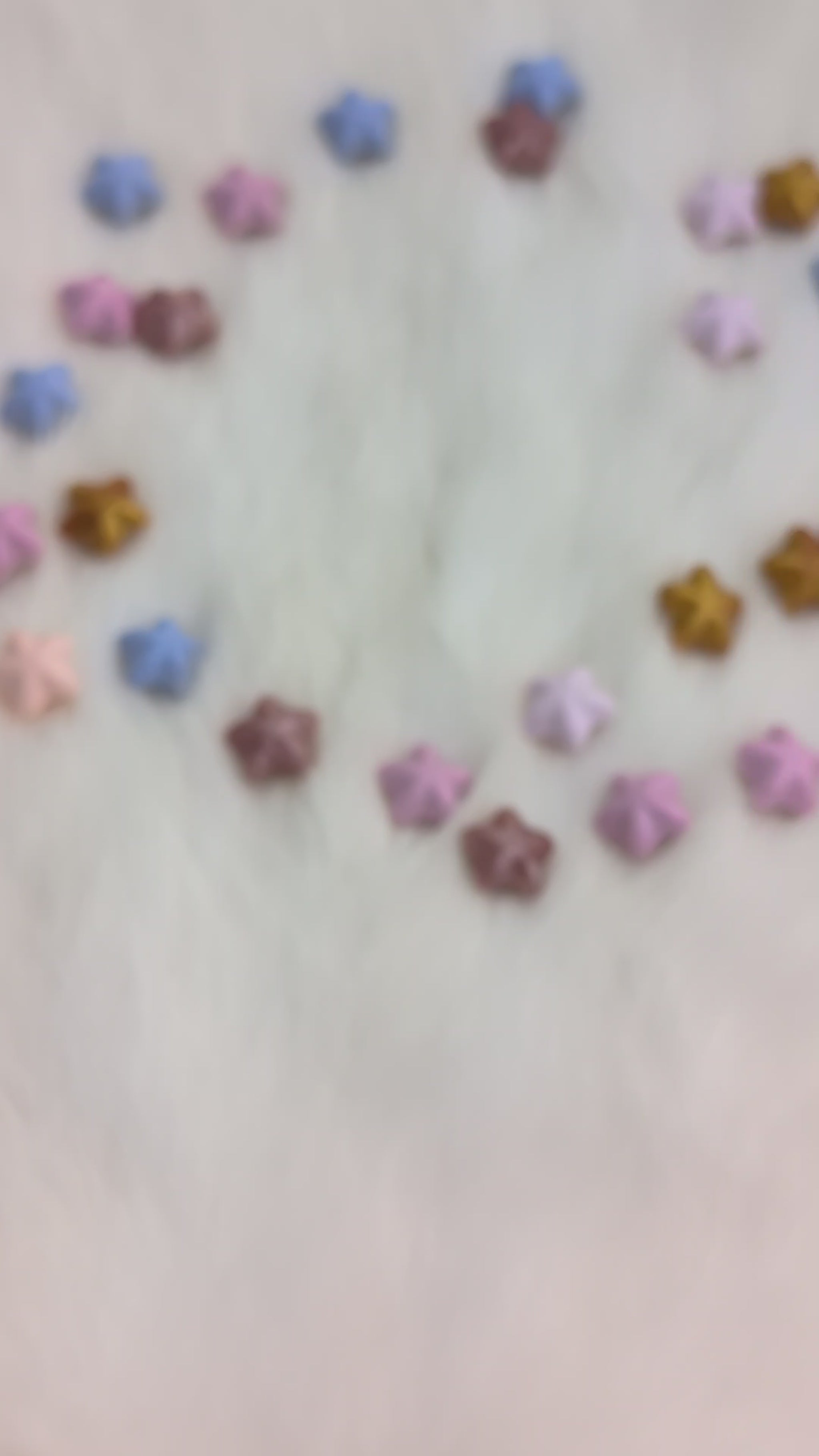 A set of translucent purple polyhedral gaming dice with gold numbering and iridescent glitter, being shook in a hand so you can see the liquid moving on the inside