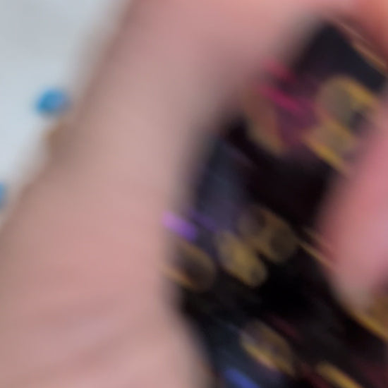 The dice show a swirling galaxy-like pattern in blue, purple, and pink tones. Shown in a video being moved around, held in a hand to show off the different angles of the dice