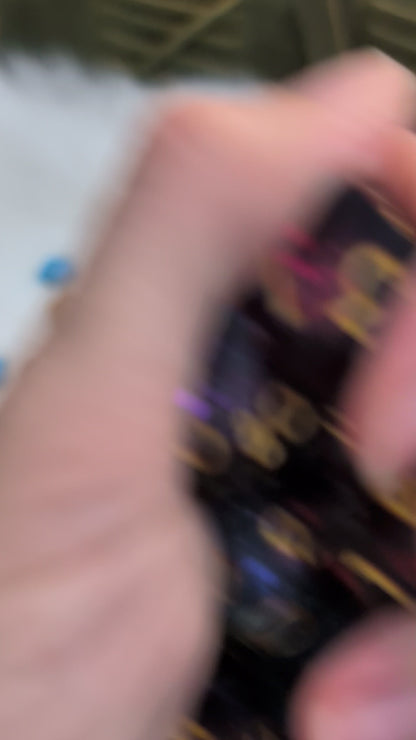 The dice show a swirling galaxy-like pattern in blue, purple, and pink tones. Shown in a video being moved around, held in a hand to show off the different angles of the dice