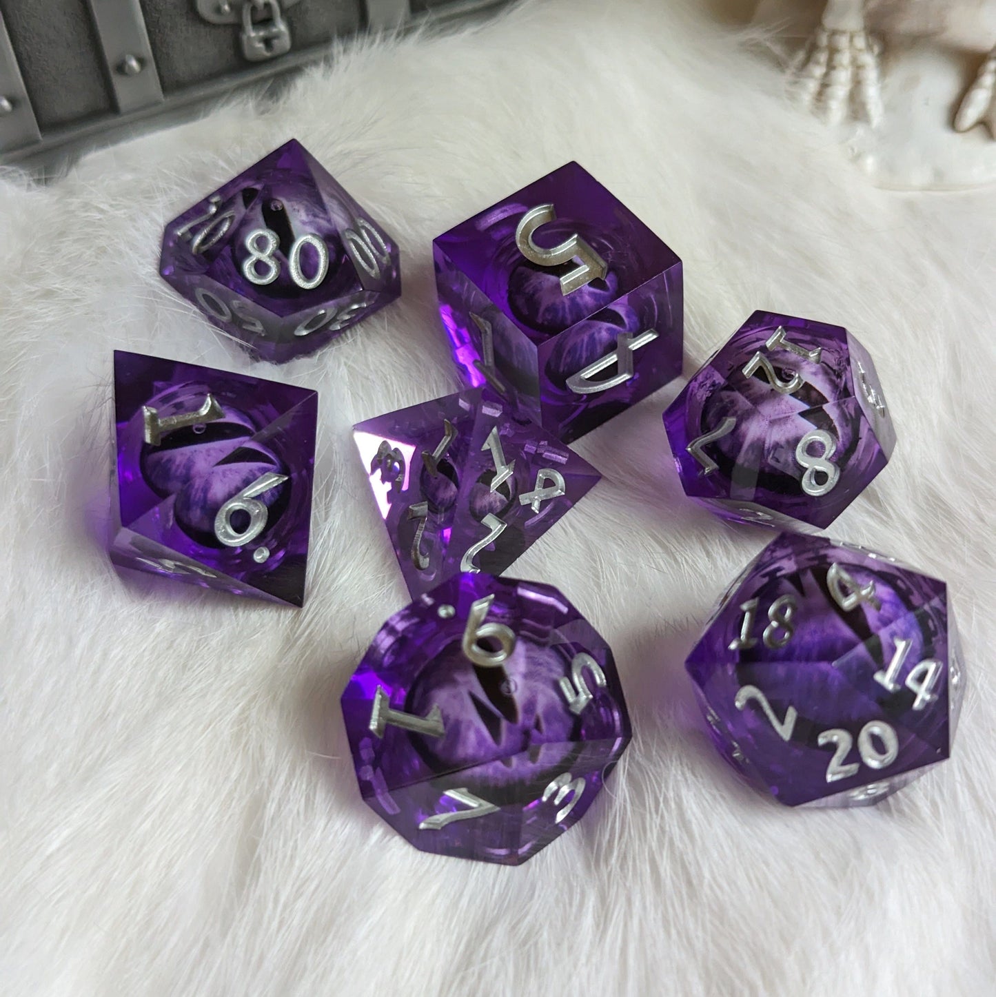 Purple Moving Eye Liquid Core DnD Dice Set on white fur for tabletop games